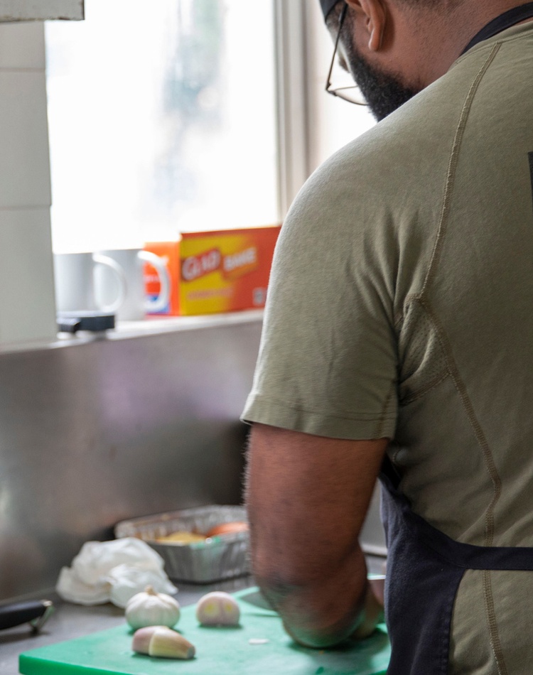 A navy officer prepares food at a military barracks.
