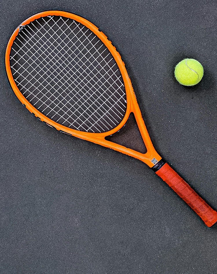 Tennis racquet and ball on ground of tennis court