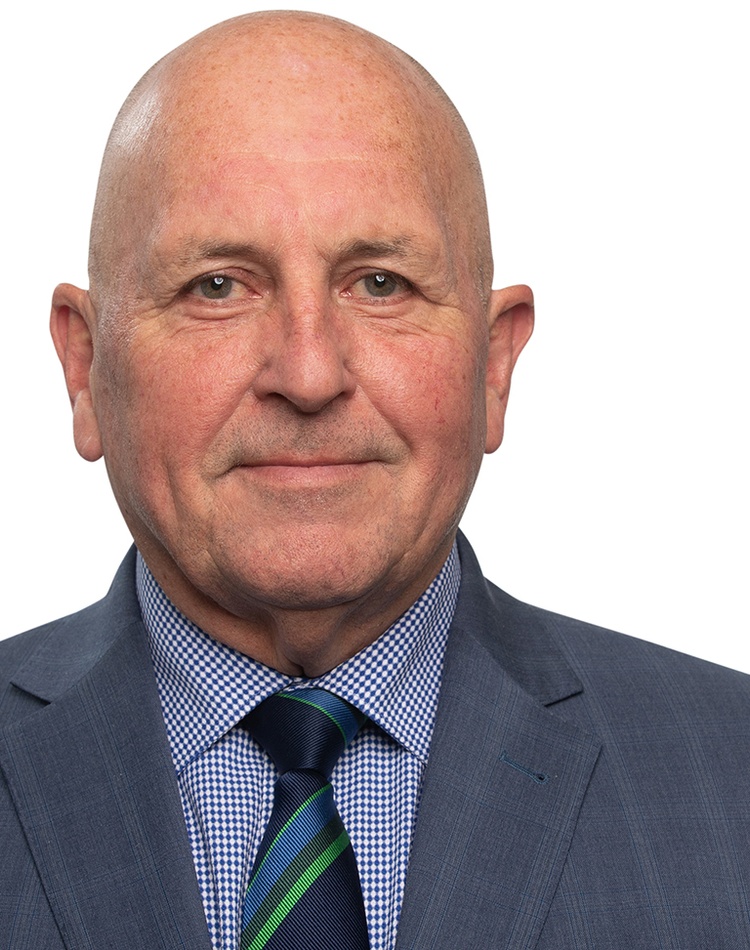 A bald-headed man in a suit and tie