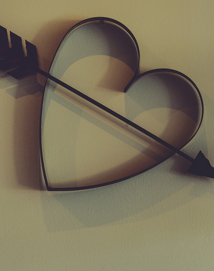 Metal cupid heart with arrow on wall