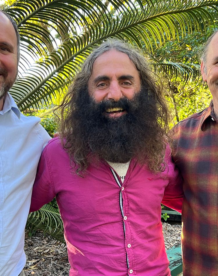 Three men in an outside garden