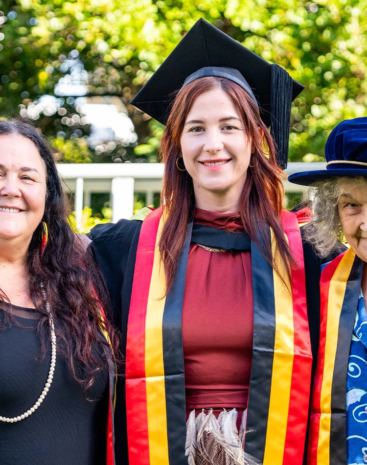 Three women in graduation robes