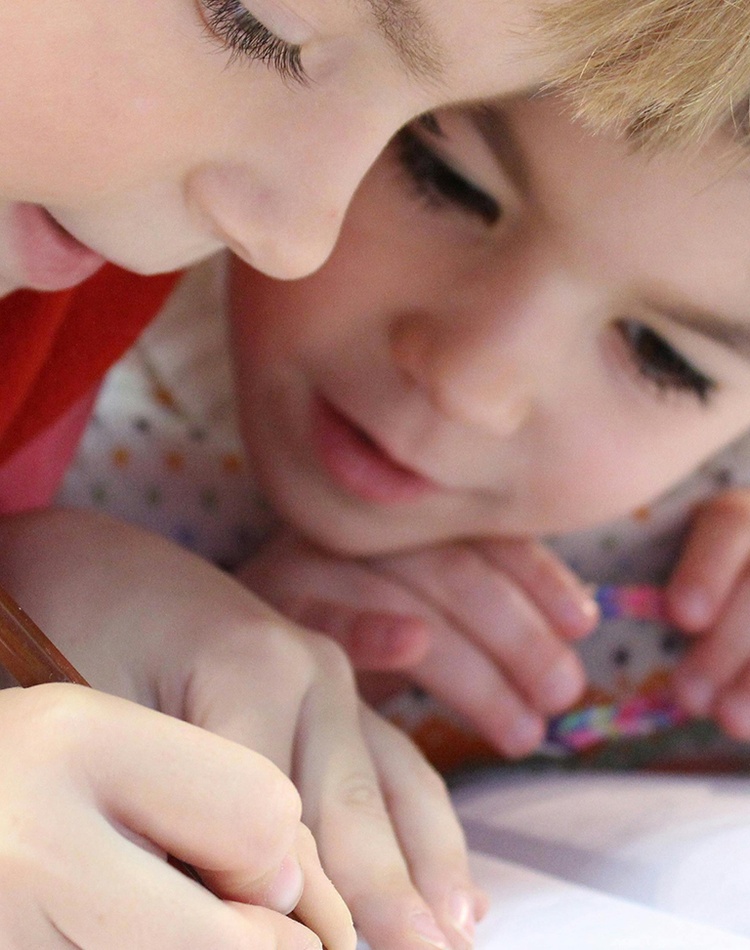 Two young girls drawing