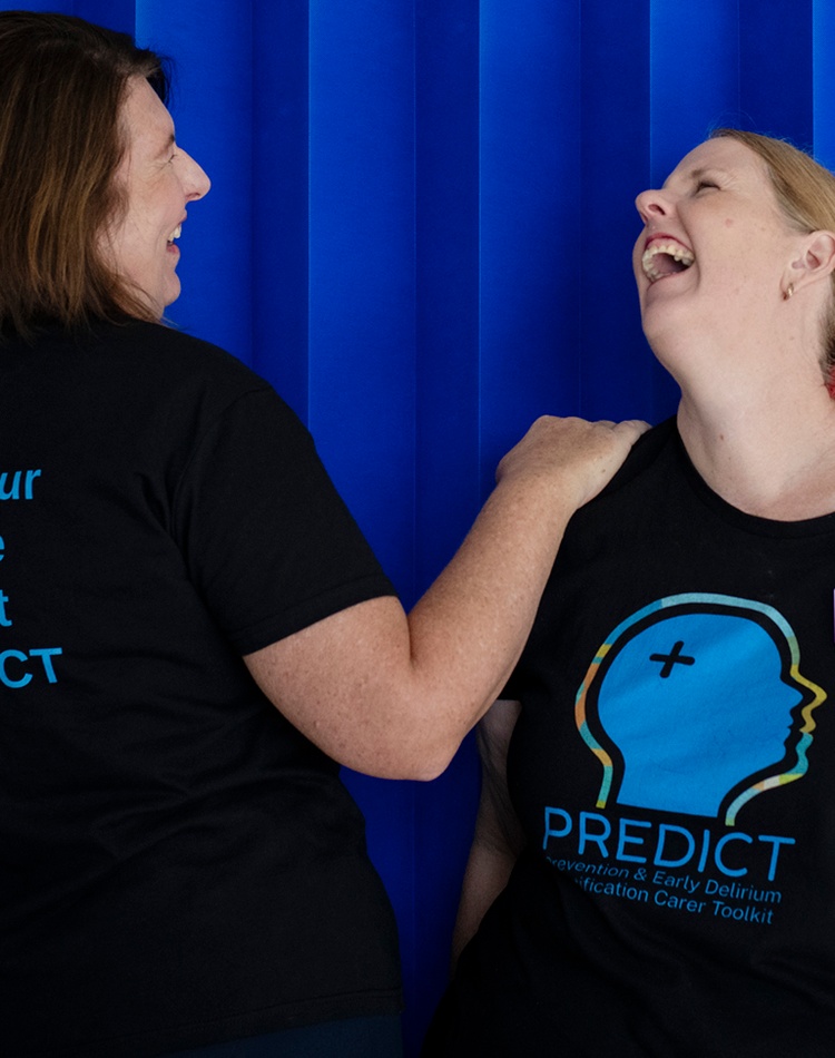 Two women in a hospital ward with PREDICT tshirts for delirium awareness