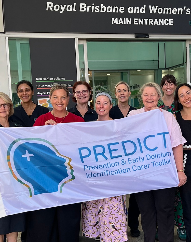 A group of people outside a hospital holding a banner