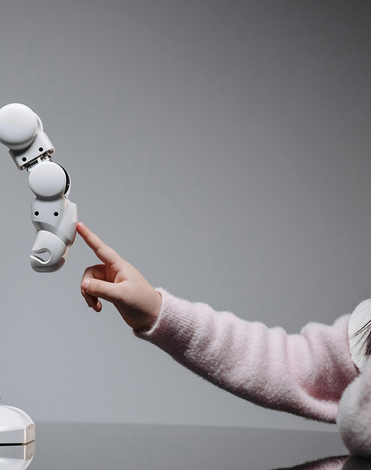 A young girl engaging with a robotic toy, highlighting curiosity and innovation