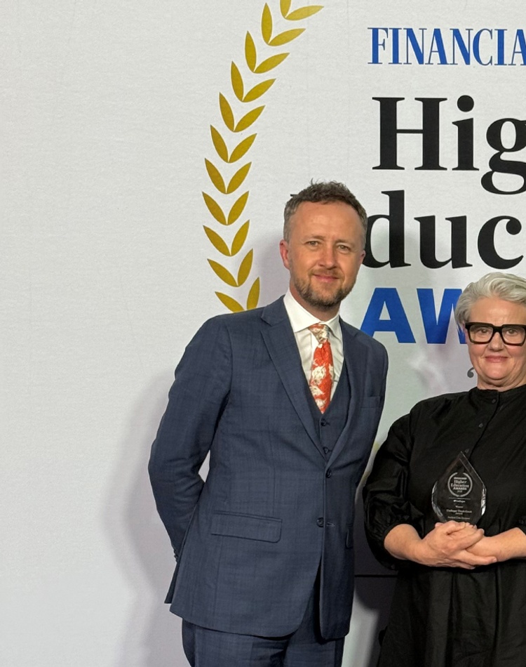 Three people standing in front of a banner