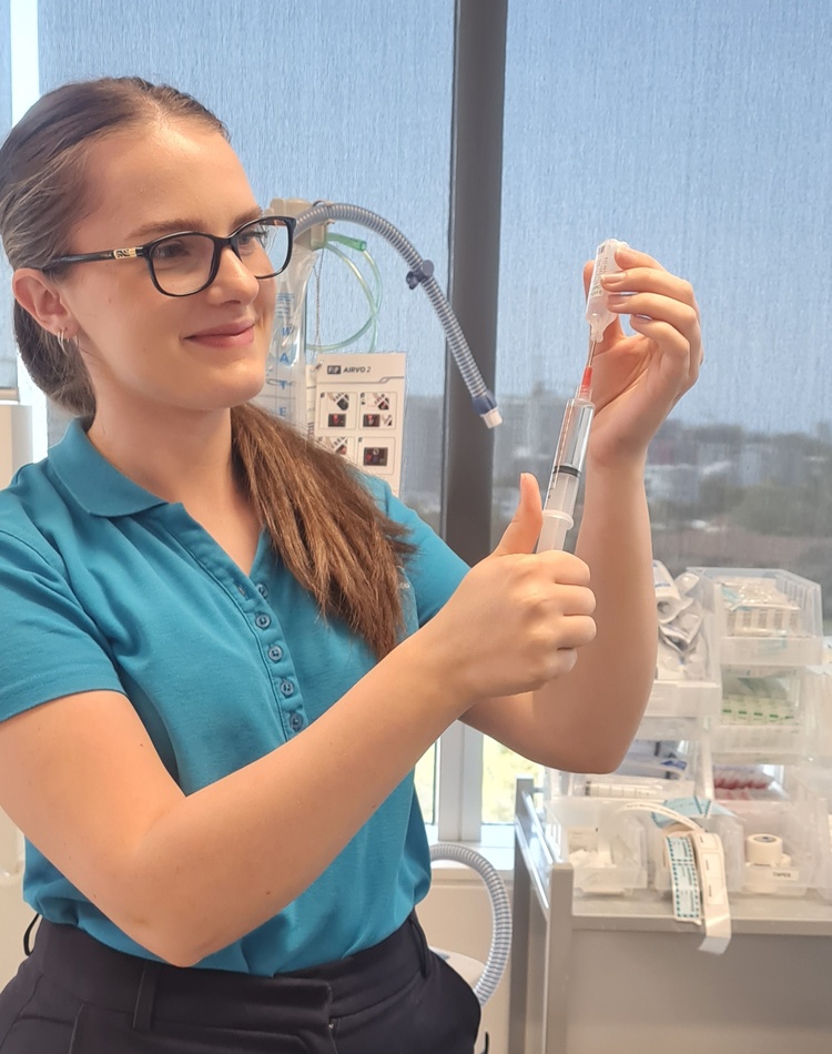 Nursing student Naomi Watson filling vial in lab