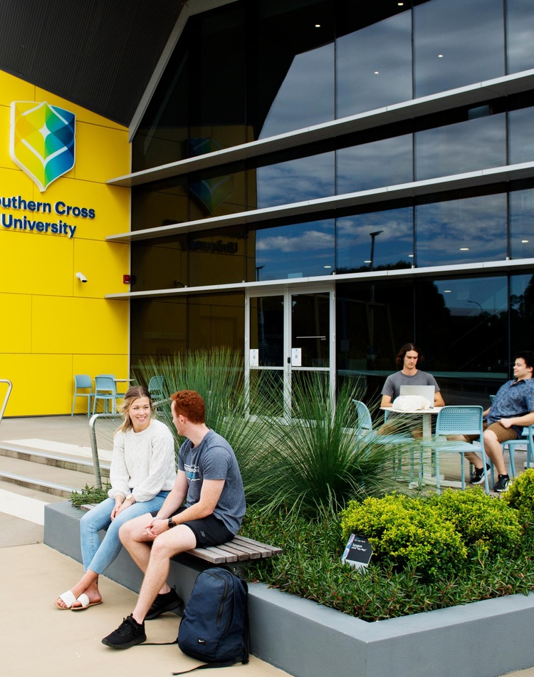 Students sitting outside U block on the Coffs Harbour campus