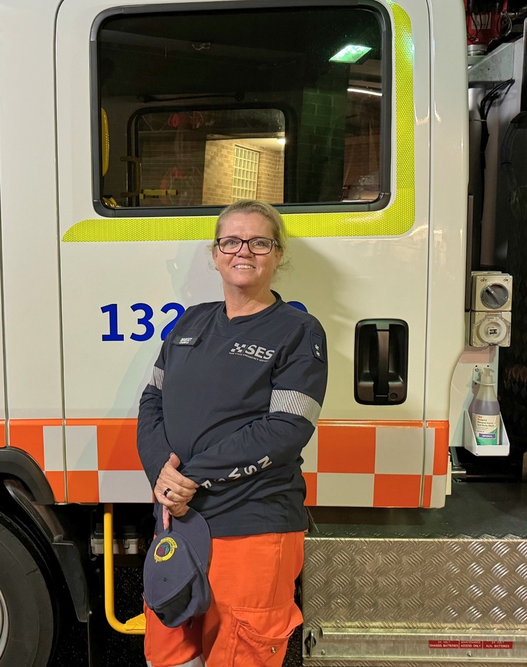 SES Deputy Unit Controller Bridget Clark stands in front on a State Emergency Services vehicle