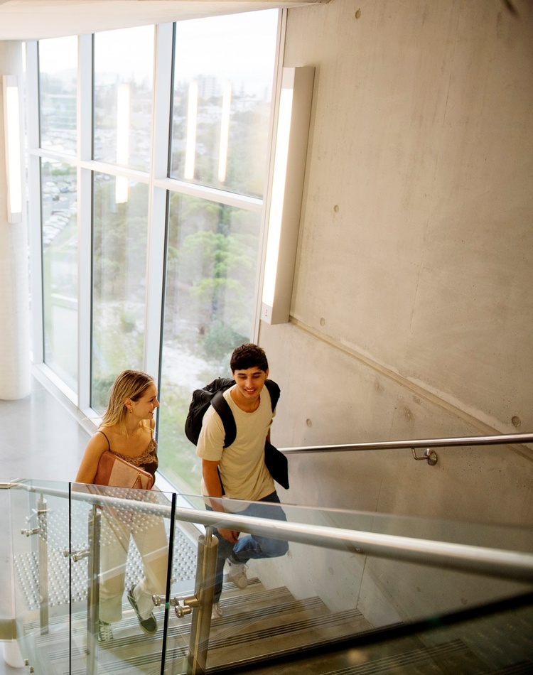 Two students climbing a staircase at the Gold Coast campus