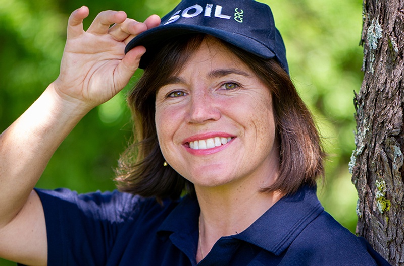 A woman wearing a Soil CRC branded hat and top