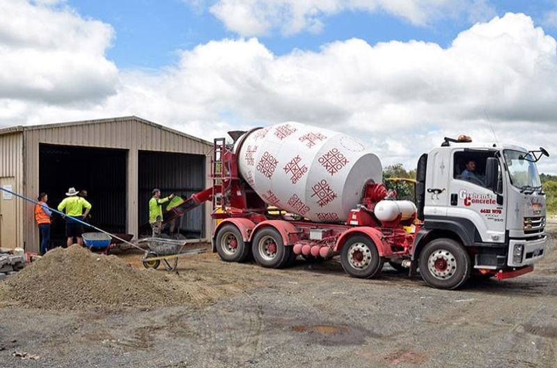 Concrete truck pours concrete for floor of shed