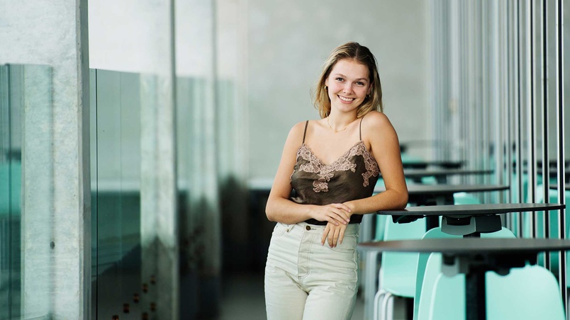 Lucia Miles leaning against table smiling