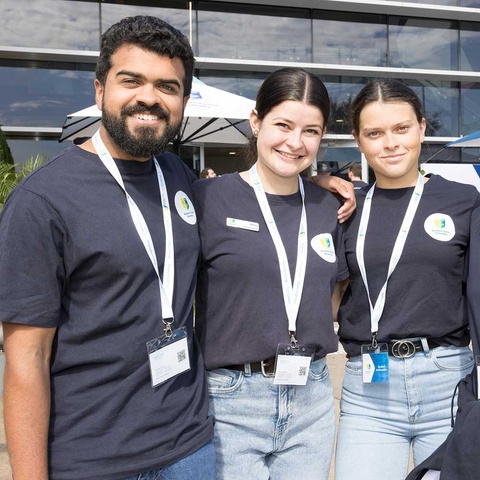 3 students smiling at camera