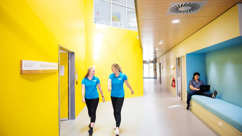 two students walking and talking
