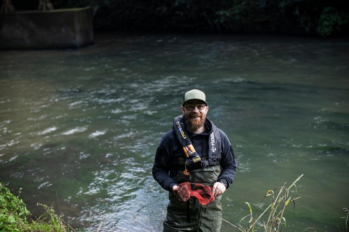 Dr Brendan Cox testing water samples in the river