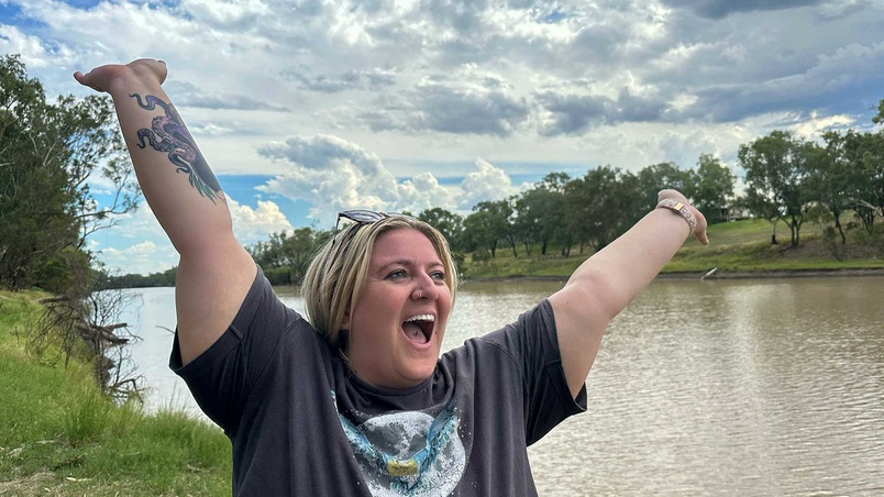 Student in front of brown river