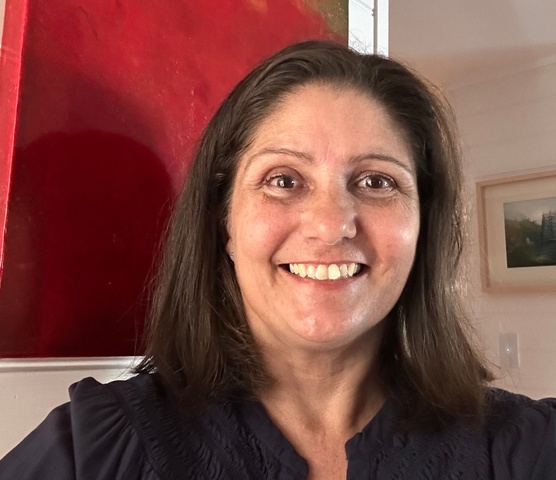 Headshot of student in front of red background