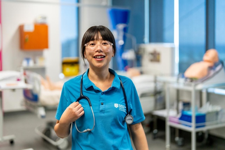 Student with stethoscope in nursing lab