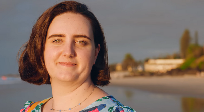 Student smiling at the beach