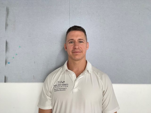 Man in white shirt against grey backdrop