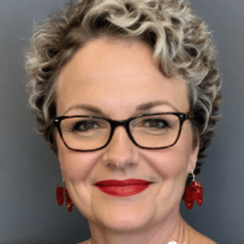 Headshot of women with glasses and red earrings