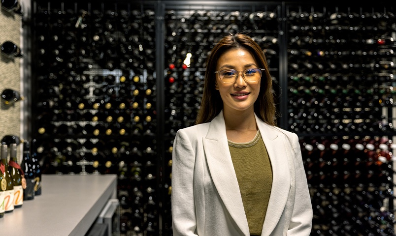 Woman in blazer standing in wine room