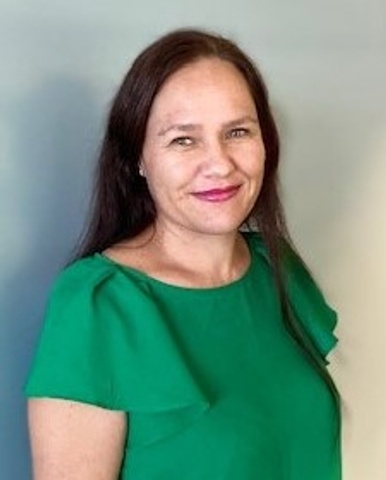 Headshot of women in green shirt