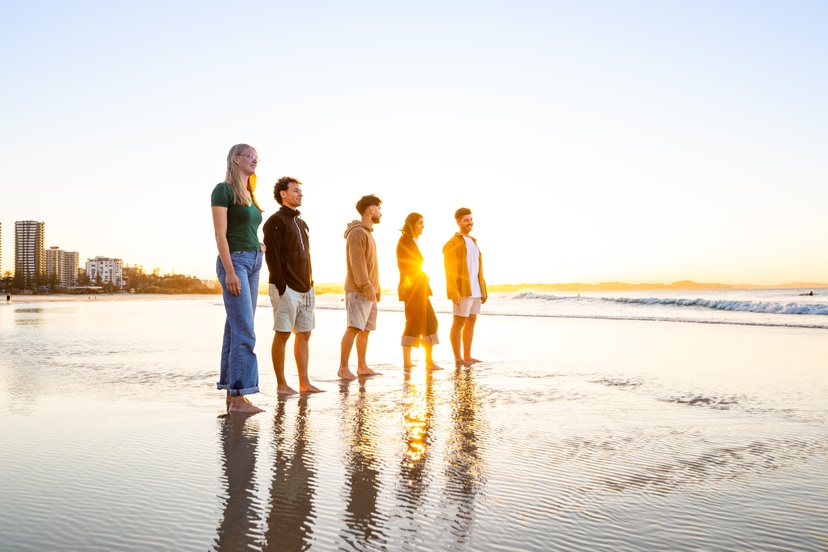 Students in sunset on beach
