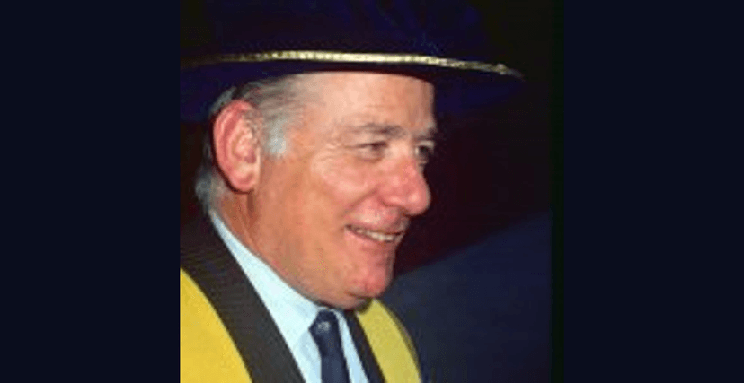 Man smiling in academic dress