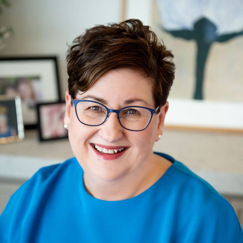 Head and shoulders of female wearing glasses and blue top - Linda Smith