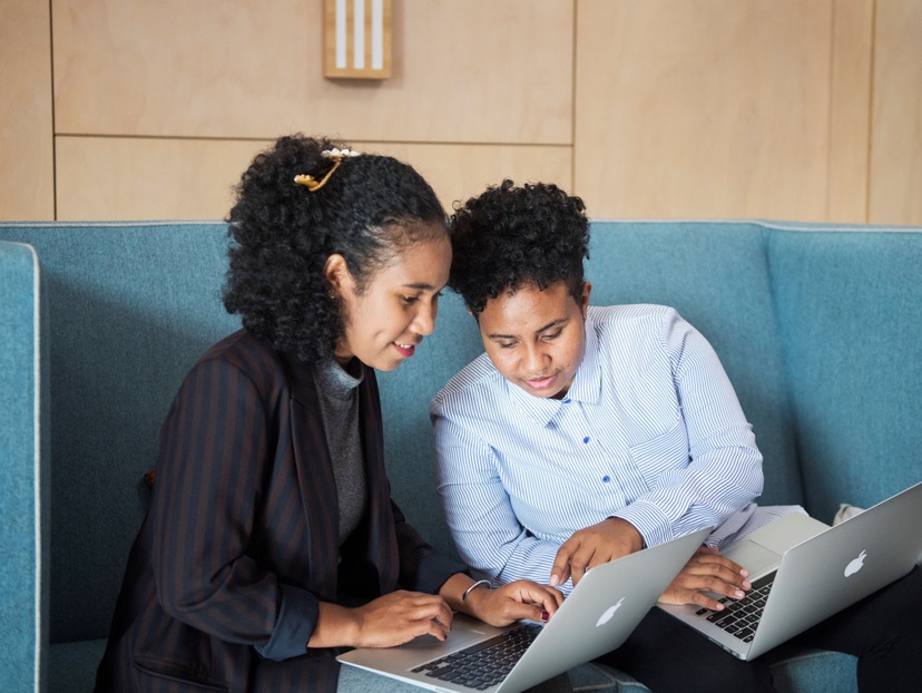 two students looking at laptop