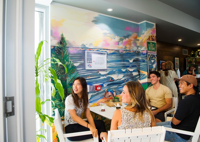 A group of students sit at the campus cafe