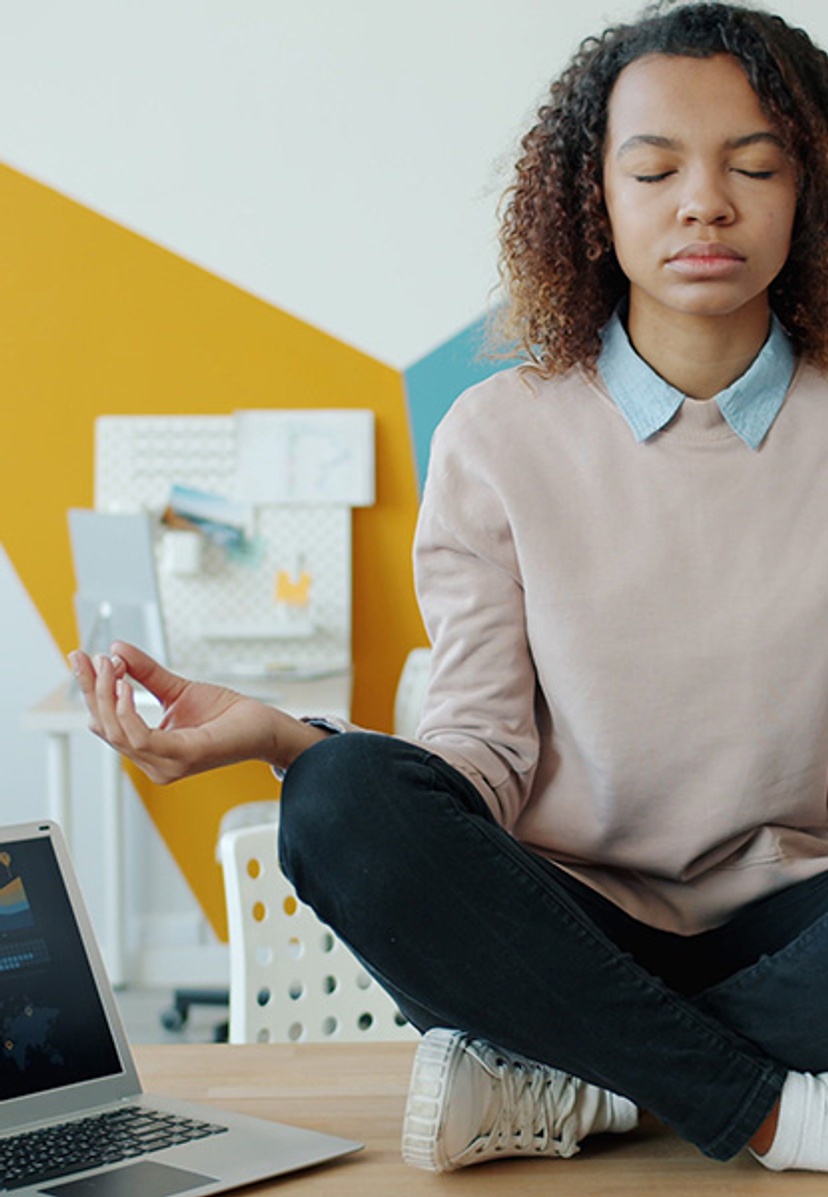 girl sitting on desk taking deep breaths