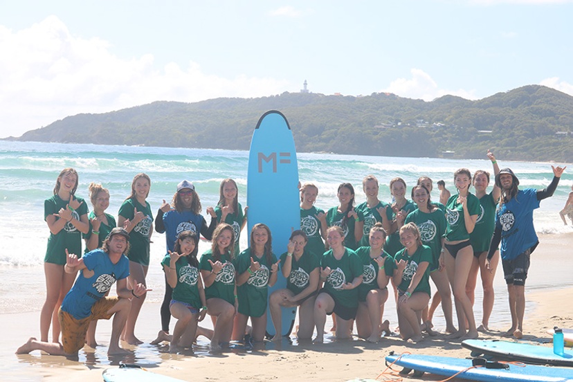 Students standing with surfboards