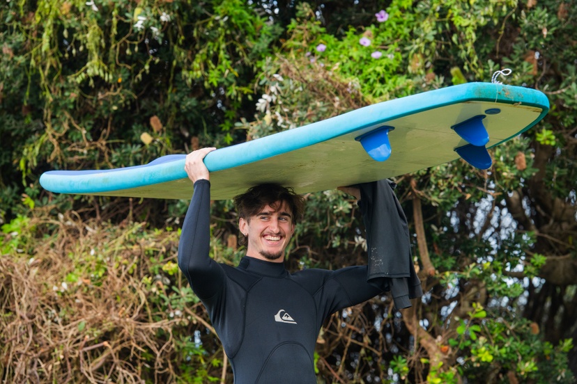 student with surfboard
