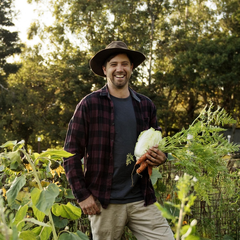 Man standing holding vegetables