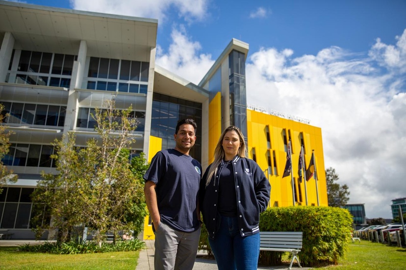 2 students standing smiling