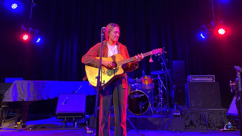 singer on stage with guitar - Georgia Grae