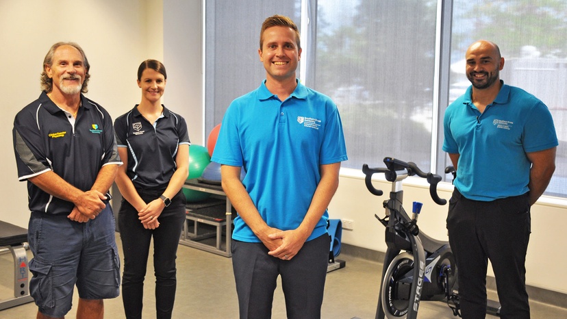 Group of people in an exercise room with fitness equipment