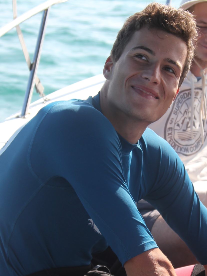 Student smiling and sitting near water