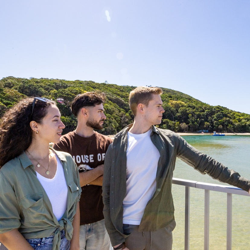 people standing on a bridge