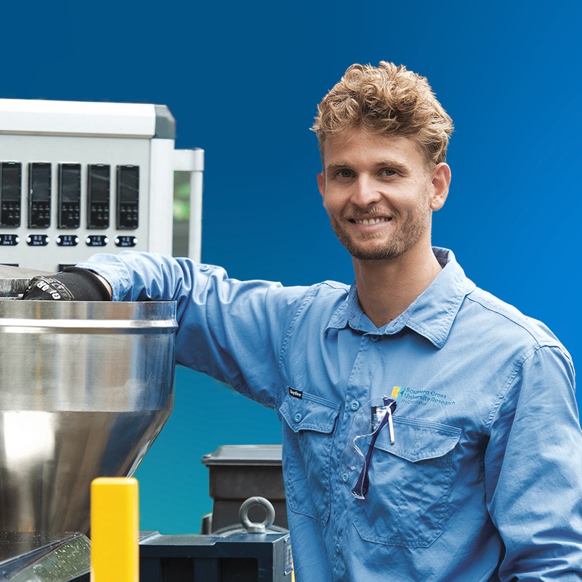 Man smiling at camera using machinery