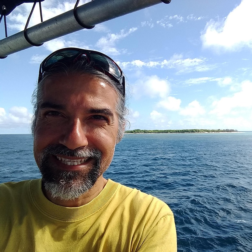 Head and shoulders of Senior Lecturer David Abrego with ocean in background