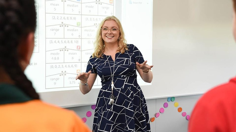 A teacher stands in front of a class