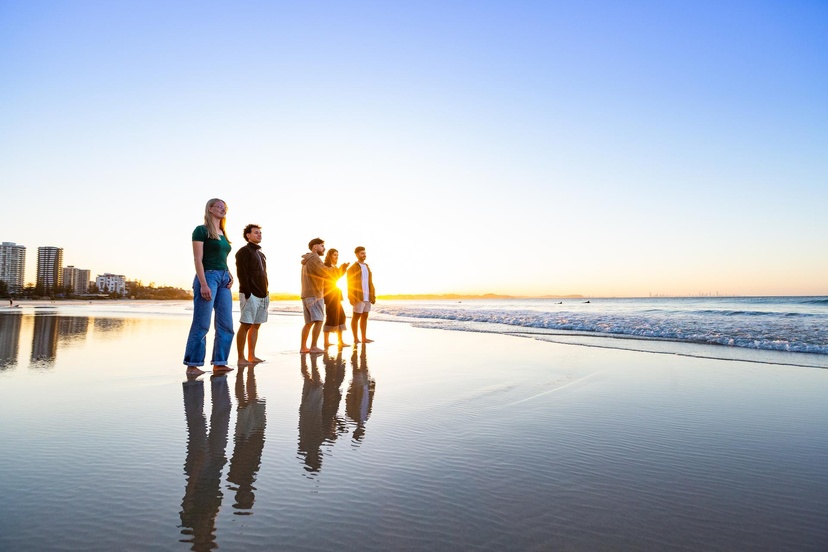 Students standing on the beach