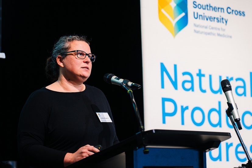 A woman standing at a lectern