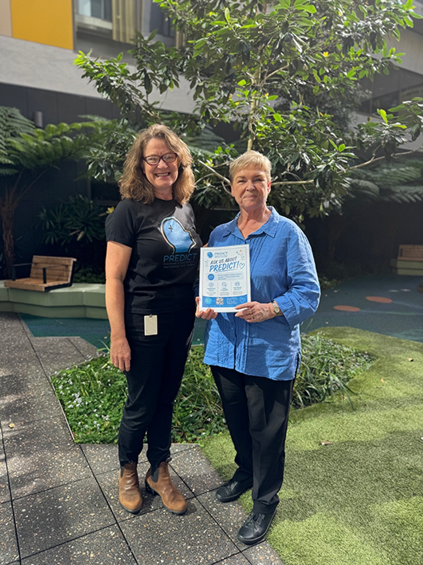 Two women standing outside a hospital