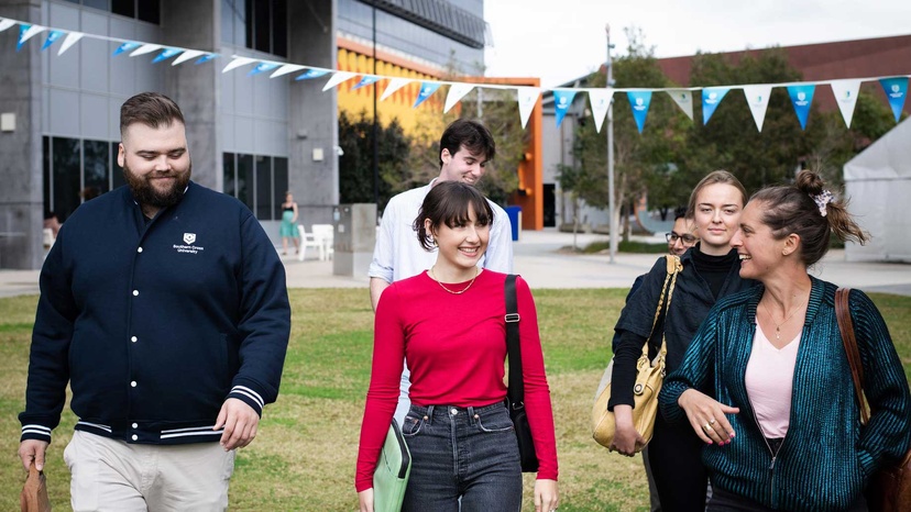 Students walking in grassy field at Gold Coast campus